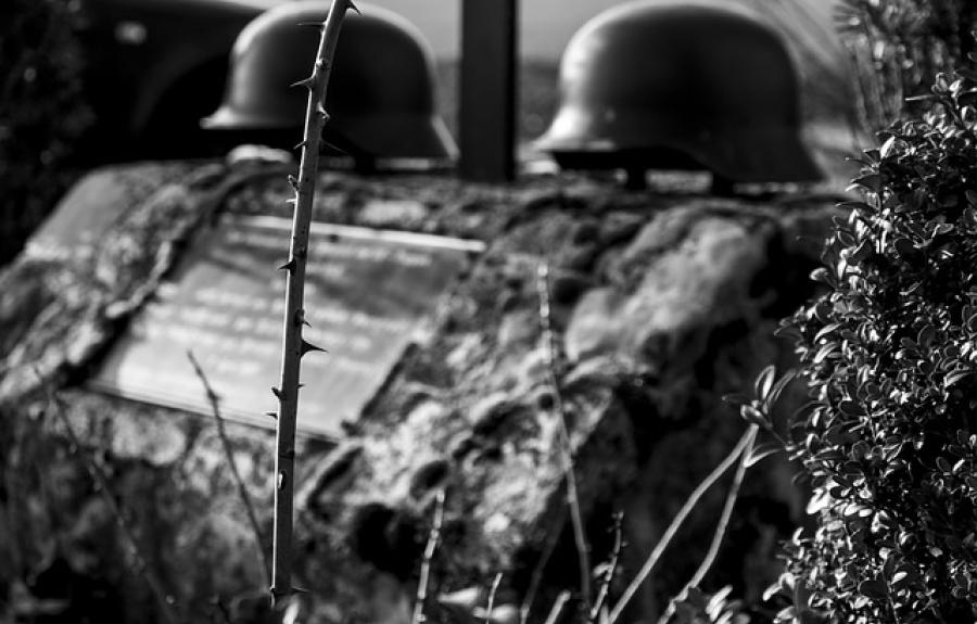 tombstone with military helmets across top