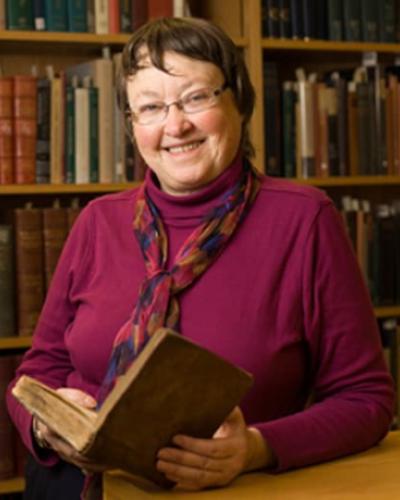 Portrait of Mary Beth Norton in front of books